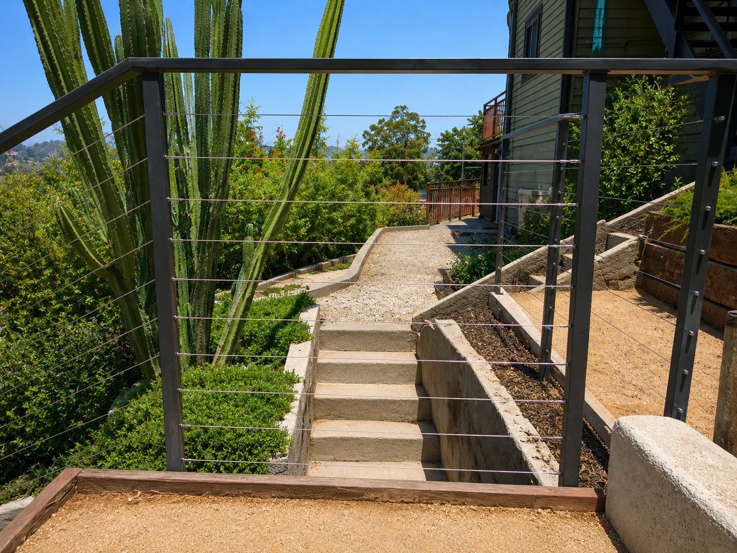 Cable railing along concrete garden steps and walkway, modern Los Angeles hillside home