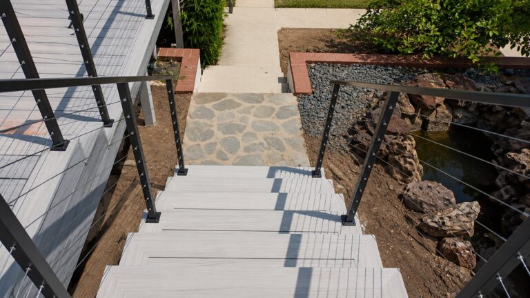 Composite deck stairs framed by stainless cable railing in Los Angeles