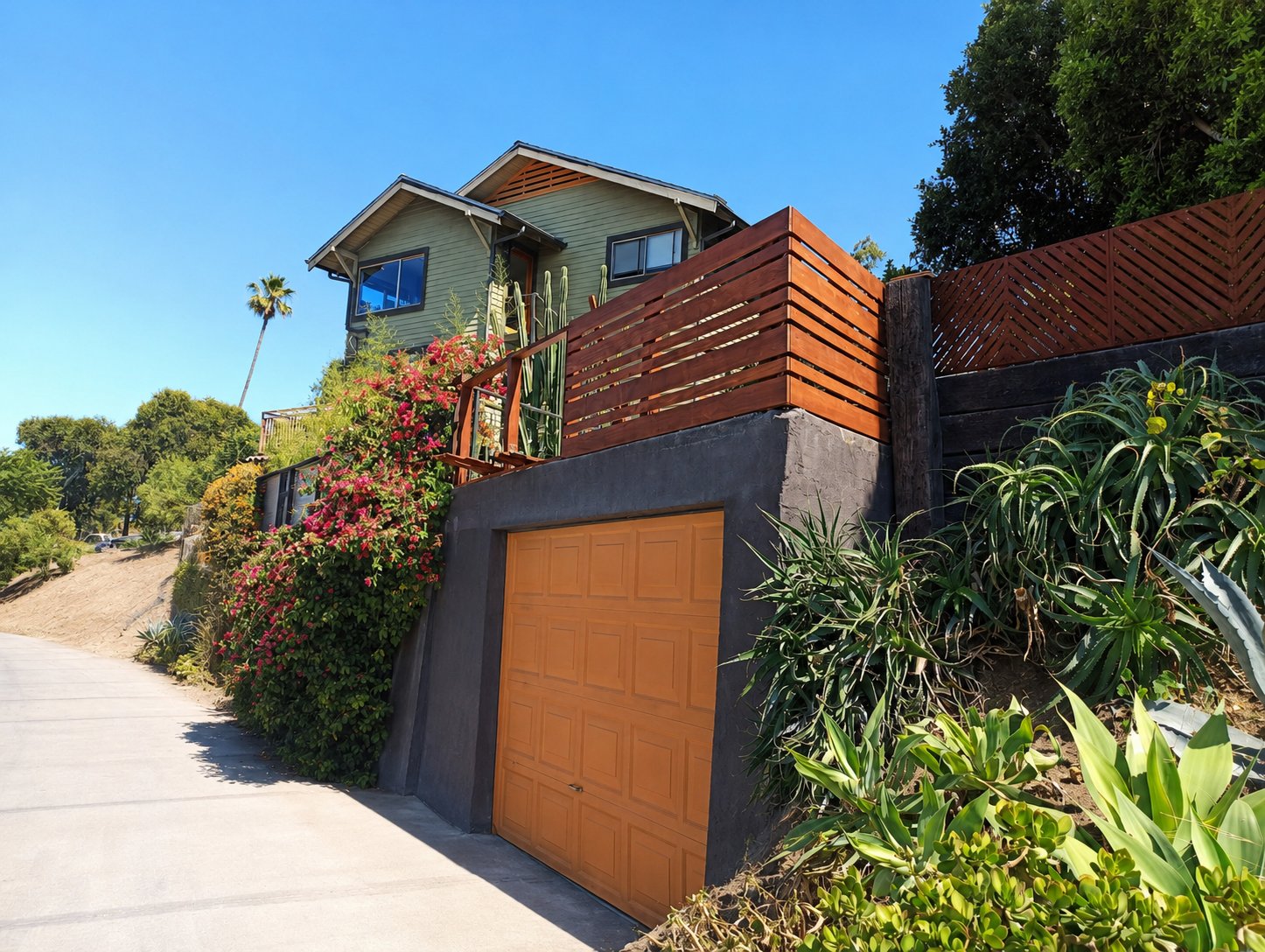 Modern horizontal cedar plank fence on hillside concrete retaining wall in Los Angeles — street view