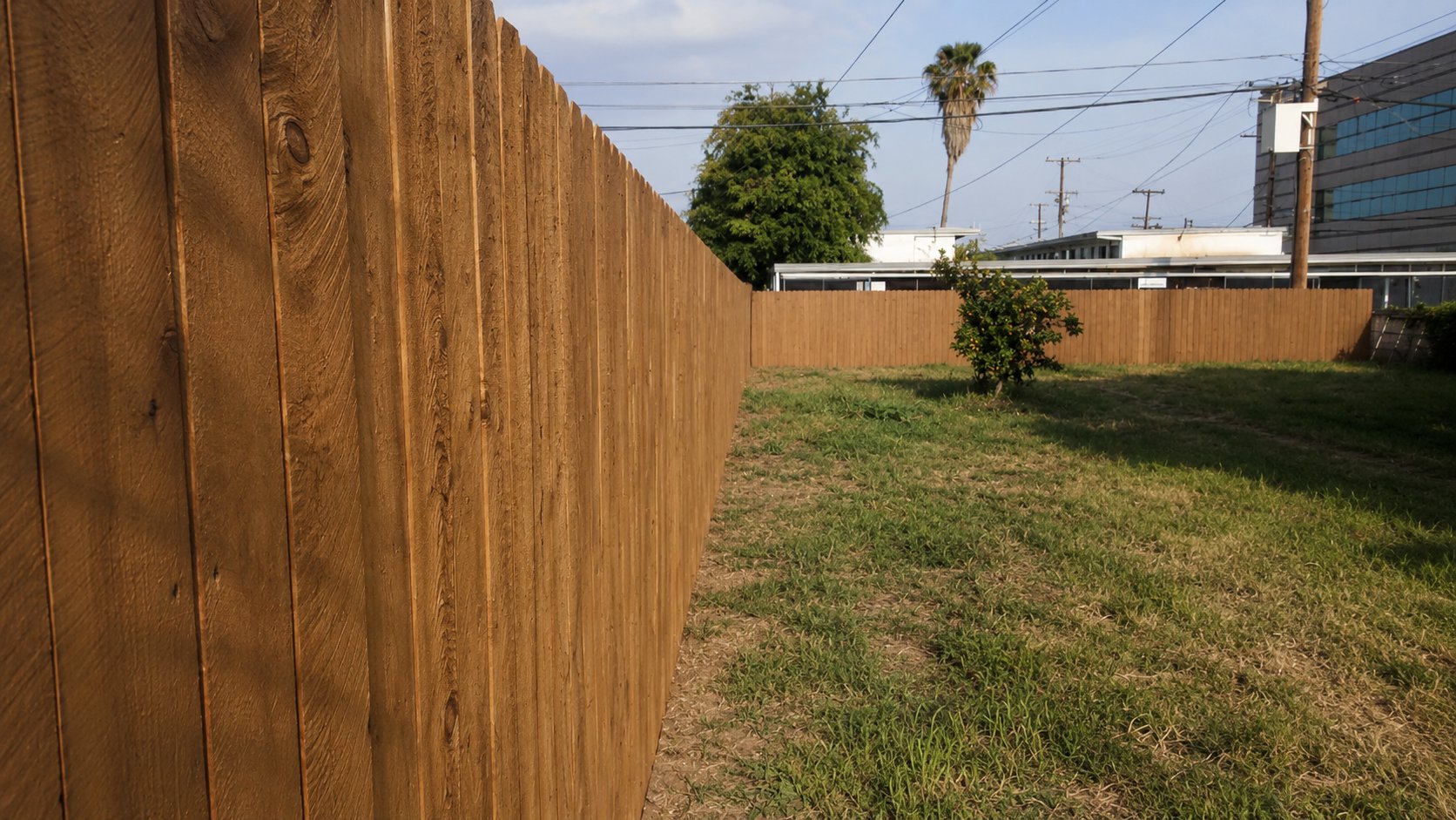 Long run of stained cedar privacy fence in a Glendale side yard, built by ProHands
