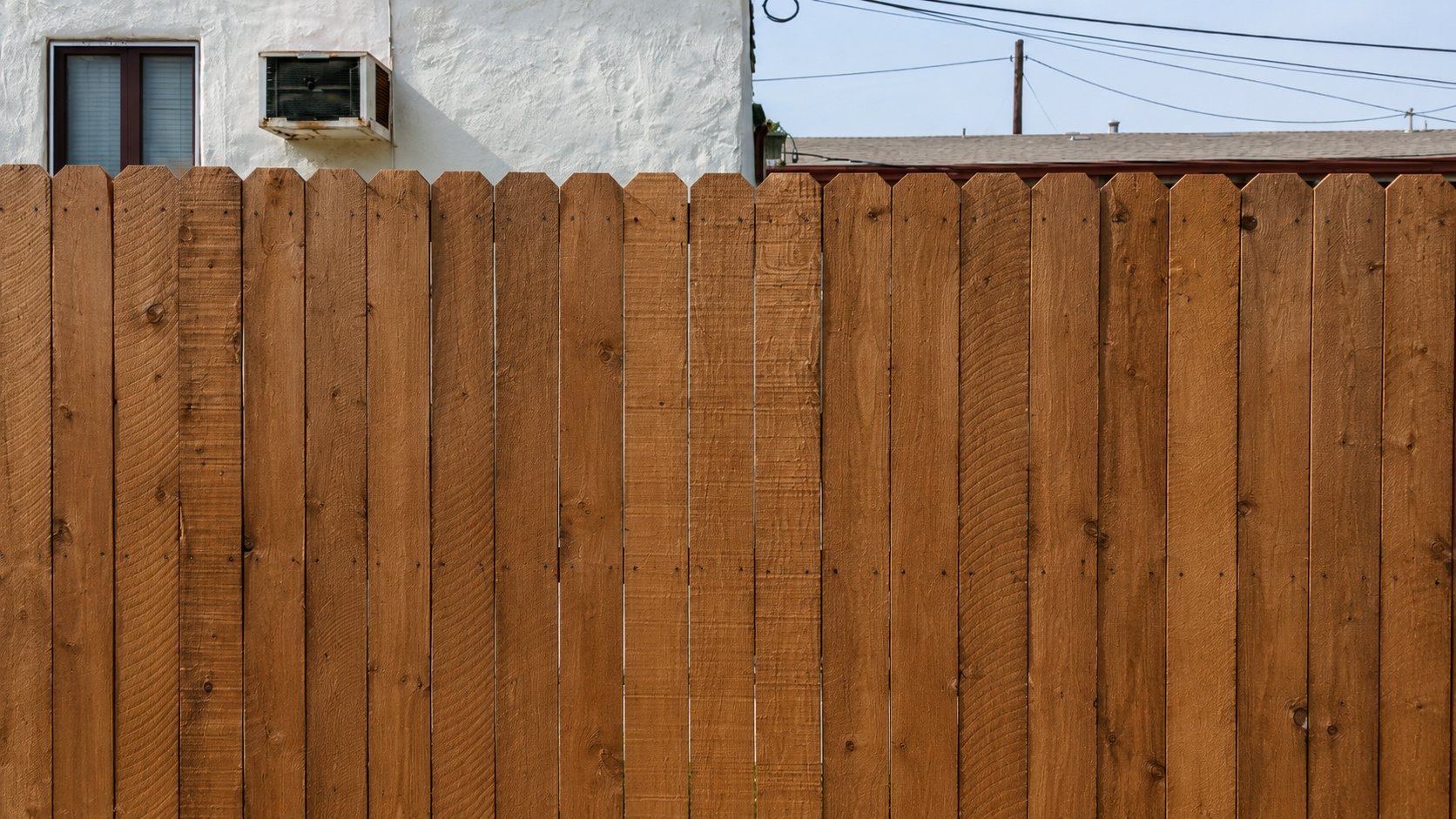 Close-up of stain finish on a custom cedar privacy fence built in Los Angeles