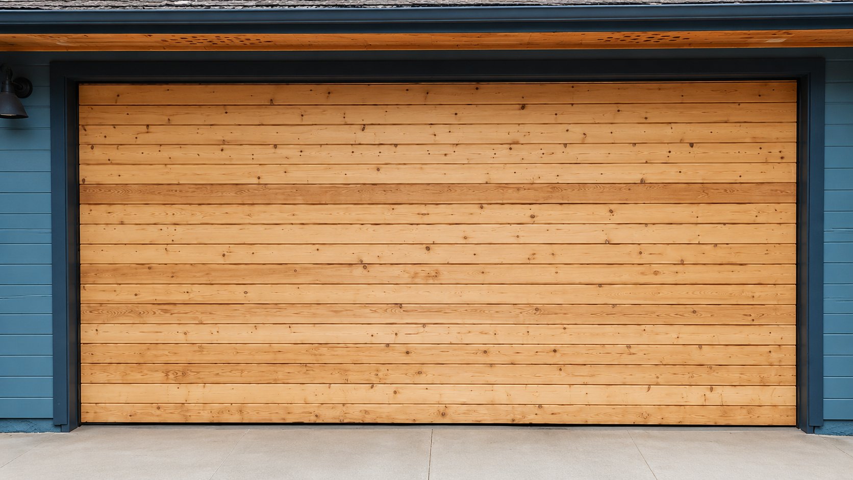 Raw unfinished cedar planks installed on custom garage door, before stain