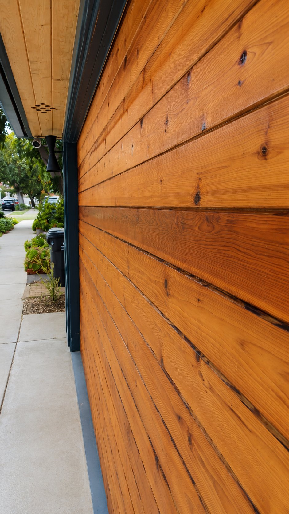 Stained cedar garage door perspective view showing horizontal plank pattern