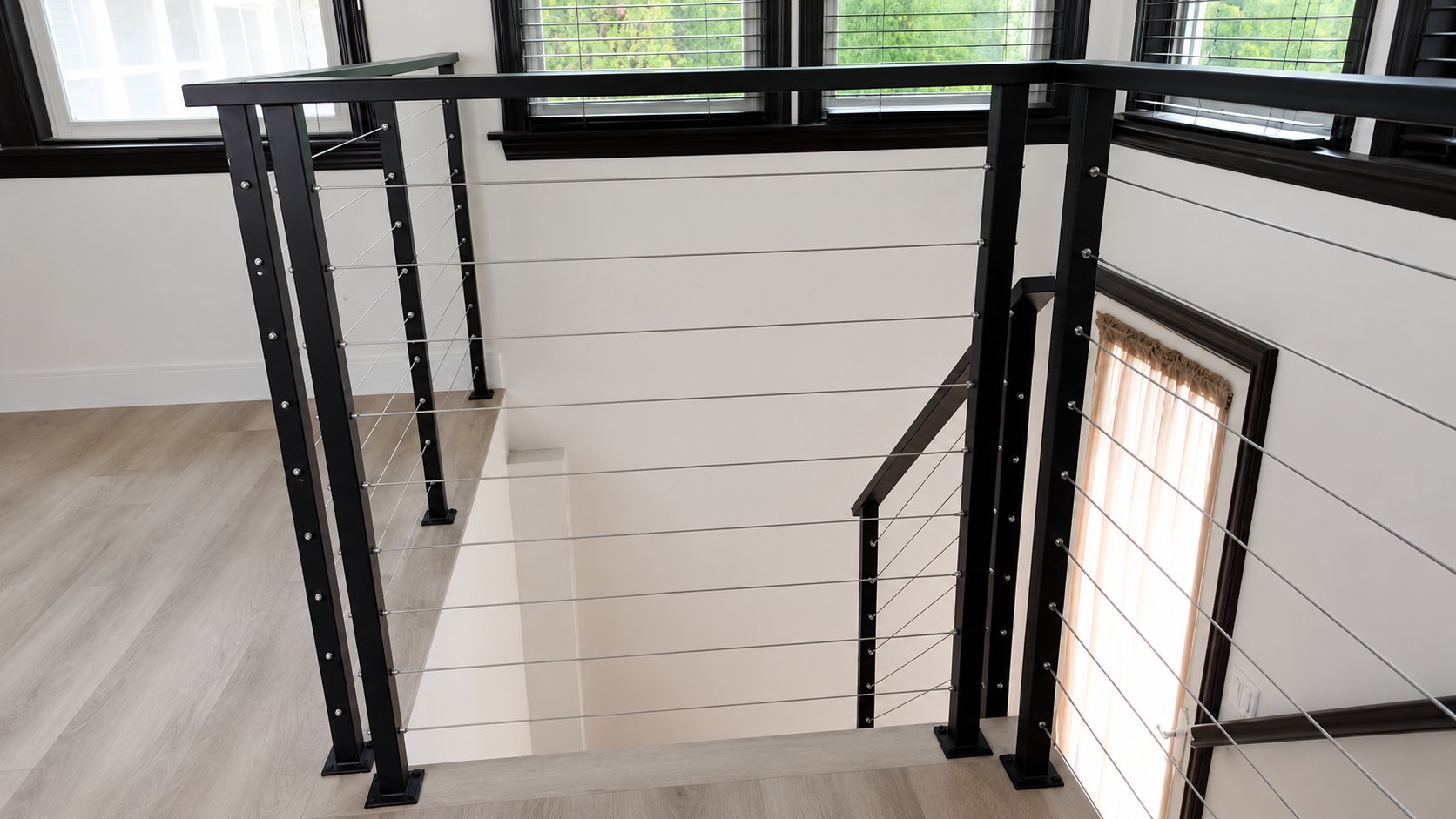 Overhead view of black steel cable railing around loft landing in modern LA home
