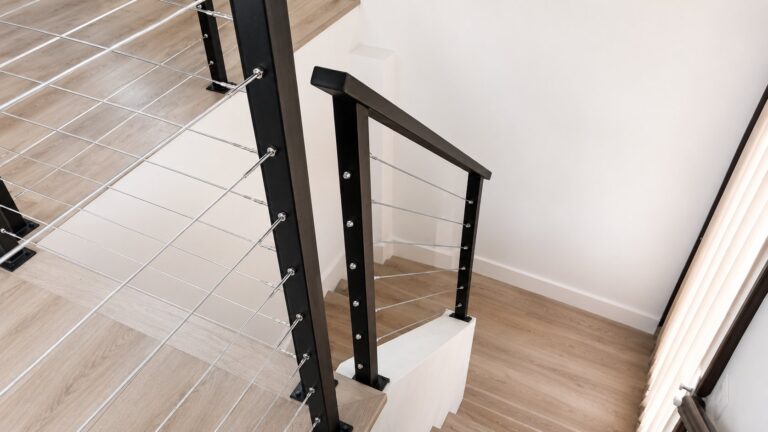 Top-down view of black steel cap rail and stainless cable