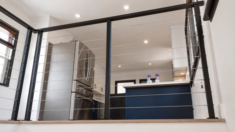 View through interior cable railing toward modern LA kitchen