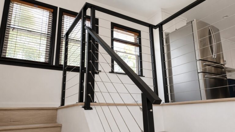 Detail of stainless cable runs and black posts on interior LA railing