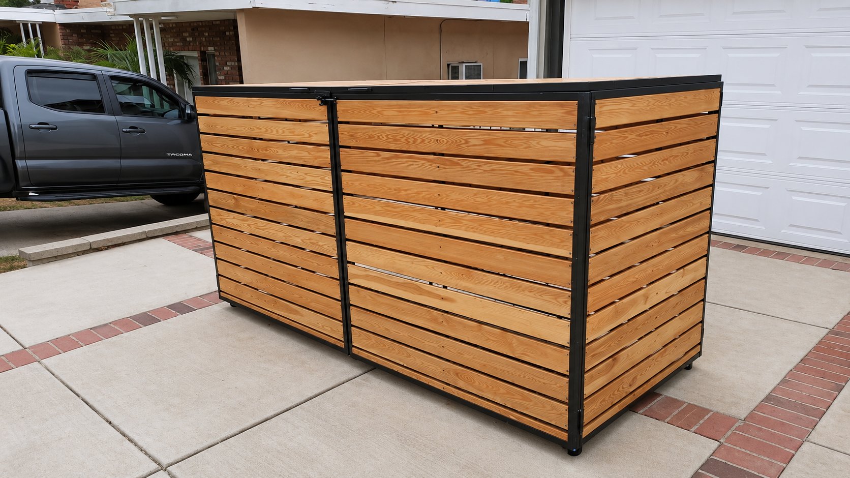 Front view of custom horizontal cedar plank trash bin enclosure with black steel frame, closed