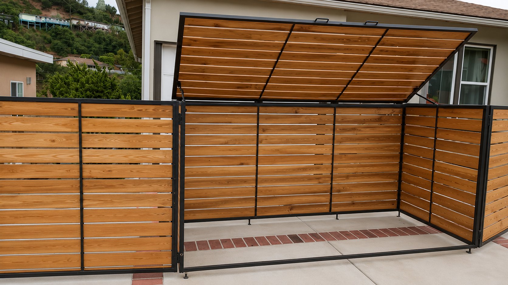 Custom trash enclosure with matching side screen fence panels along the driveway in Los Angeles