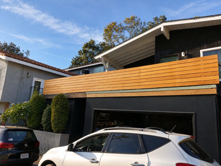 Cedar-and-steel balcony privacy screen viewed from the street — Los Angeles