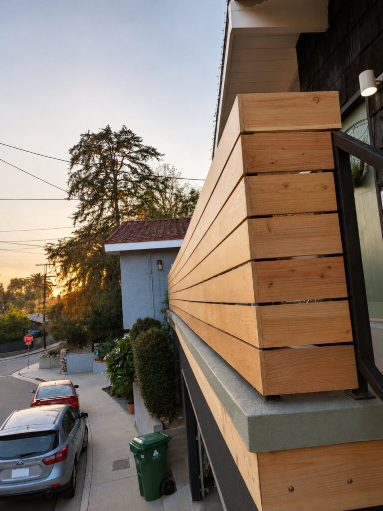 Sunset side corner of the cedar-and-steel screen — Los Angeles
