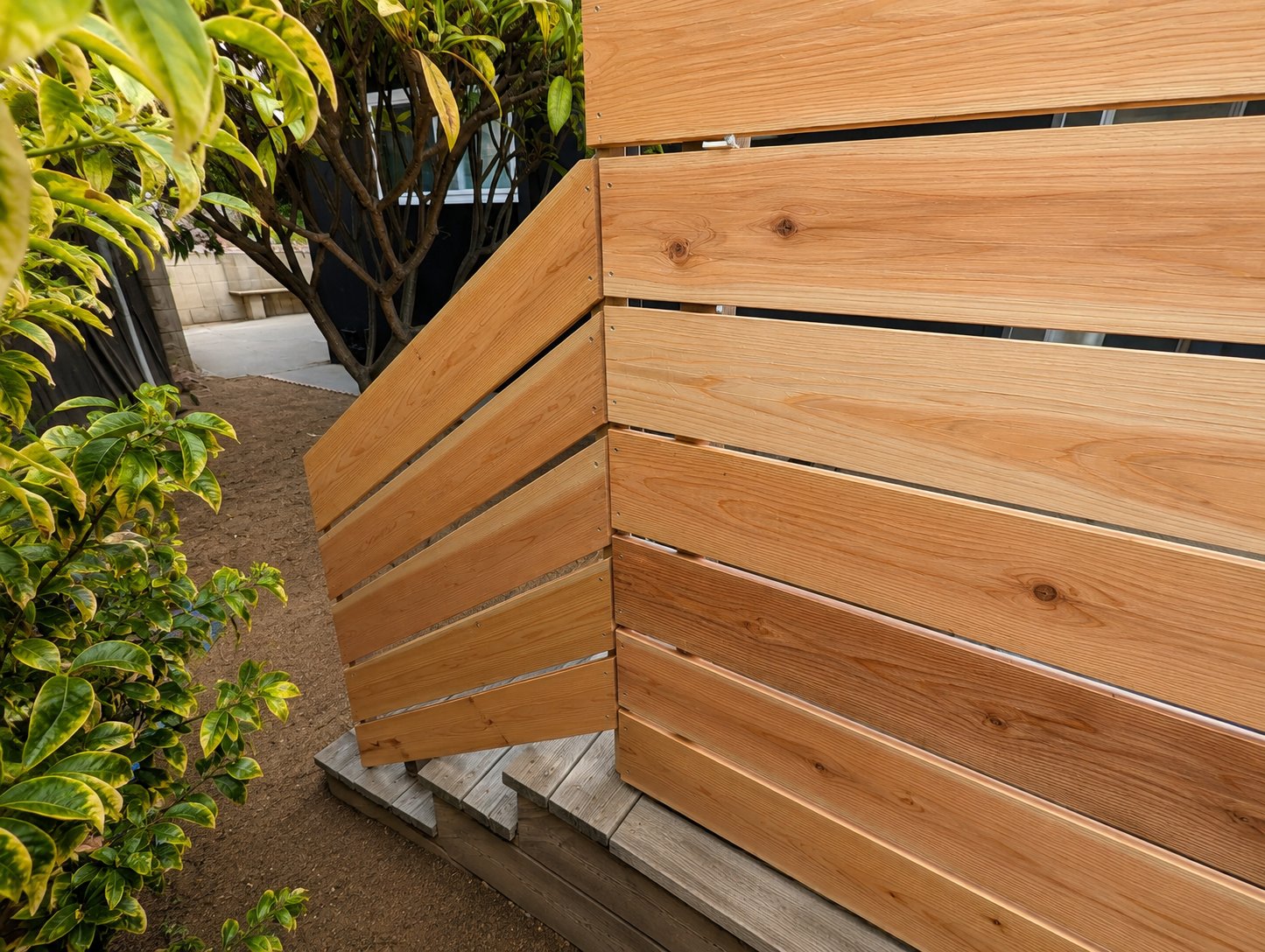 Tight detail of the cedar slats meeting the welded steel corner — Los Angeles