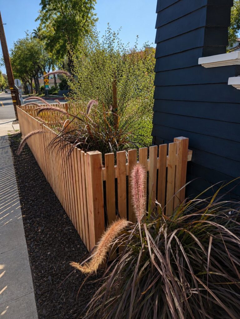 Natural cedar picket fence side angle with ornamental grass - Los Angeles