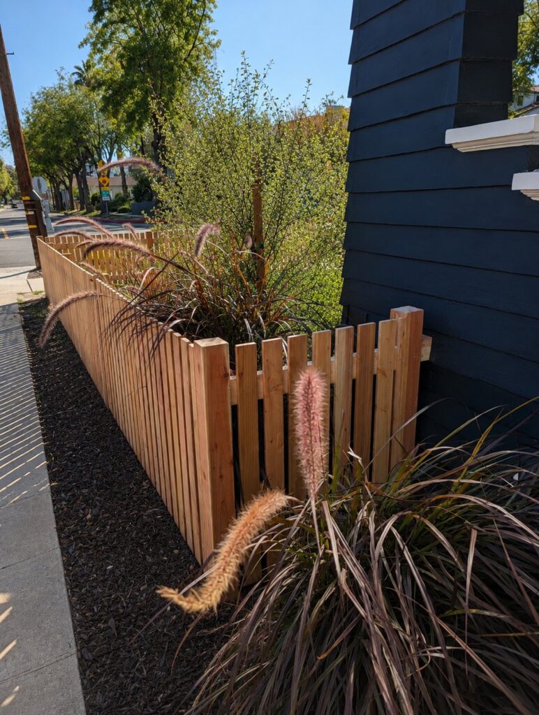 Before — side angle of the natural cedar fence with ornamental grass — Los Angeles