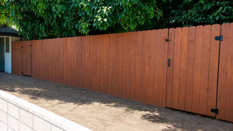 Long classic vertical-board cedar fence with matching gates, LA