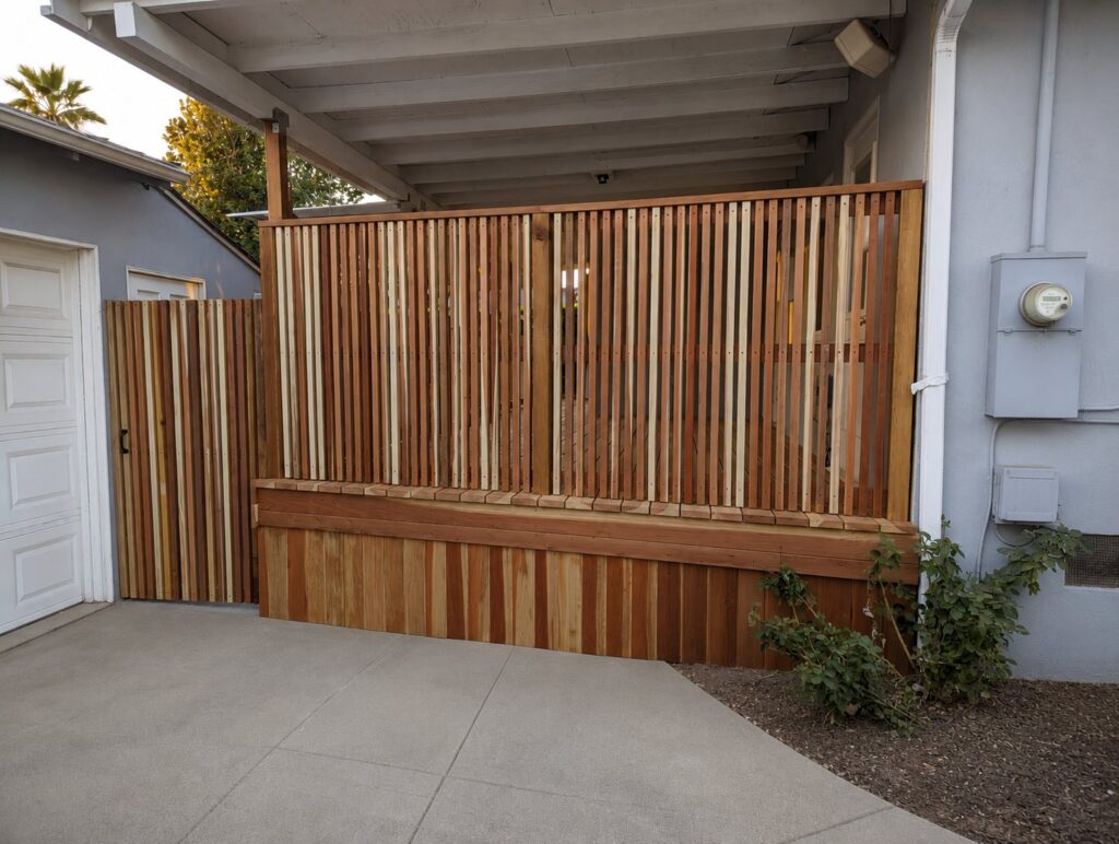 Vertical-slat redwood privacy screen with horizontal panel base — Los Angeles