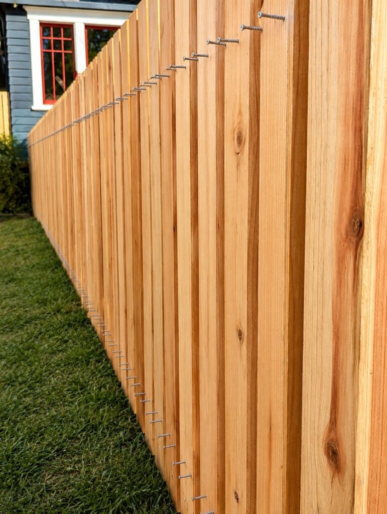 Matching redwood boundary picket fence — same lumber as the deck — Los Angeles