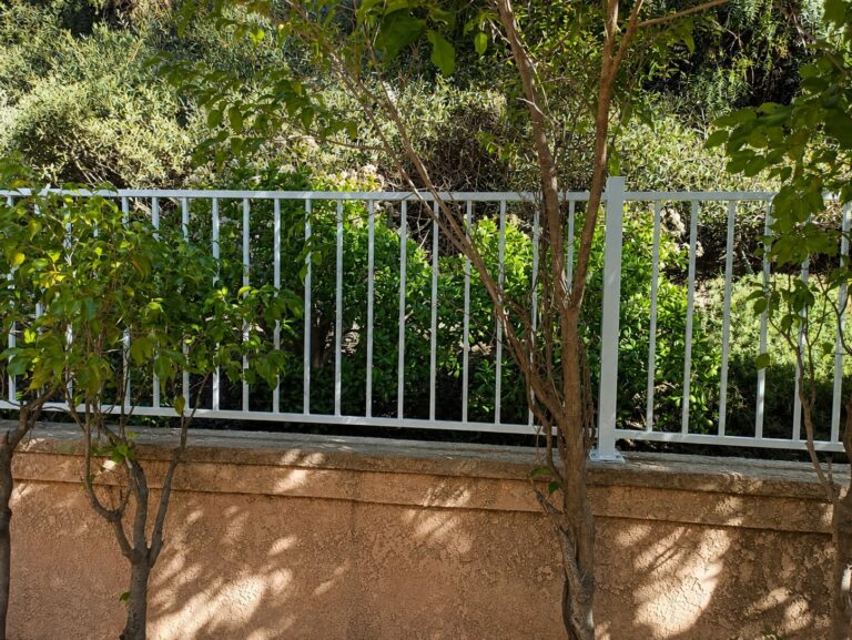 Steel picket railing wide section view with mature garden — Los Angeles