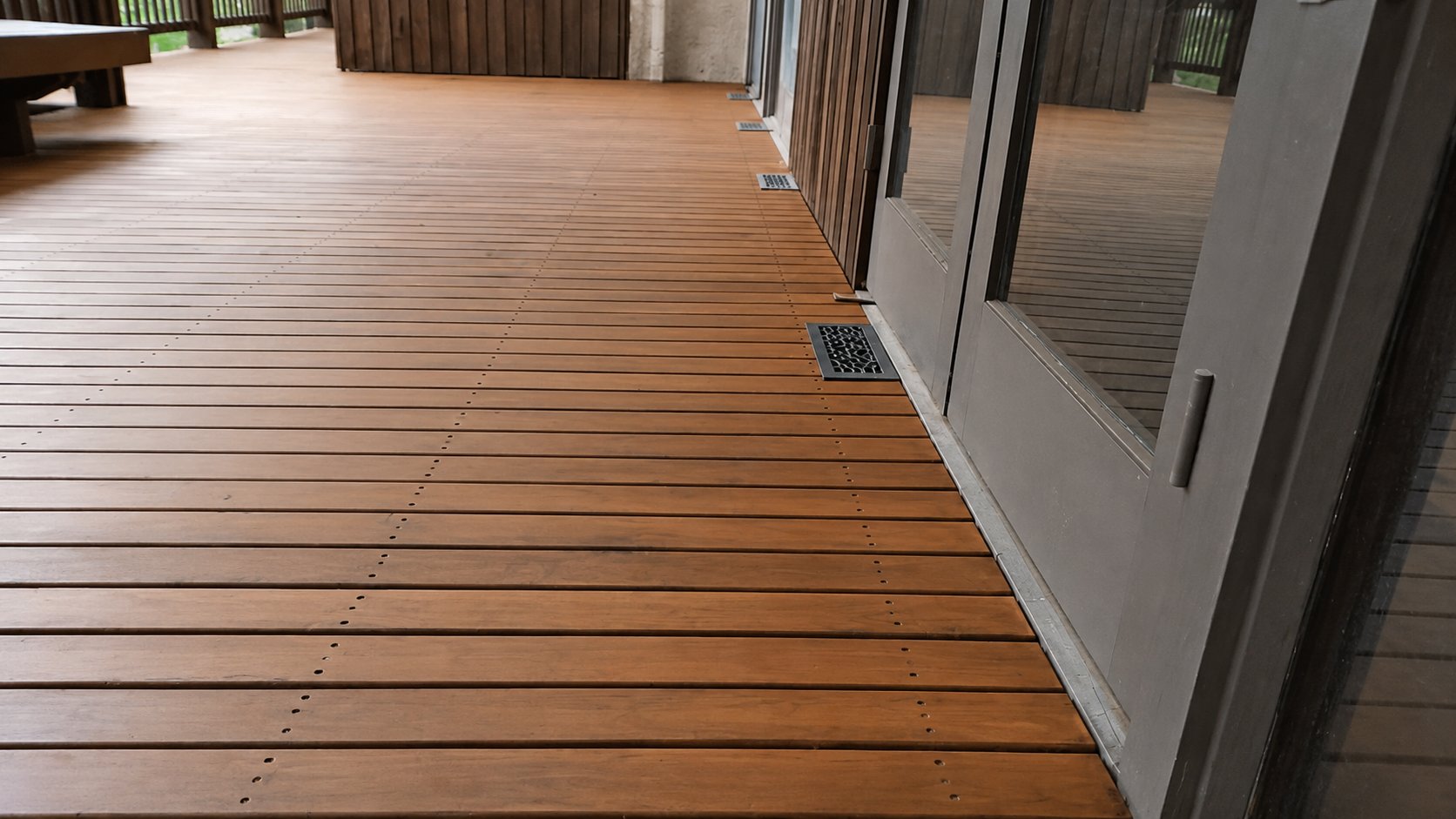 Top-down view of premium wood deck stairs with stained treads