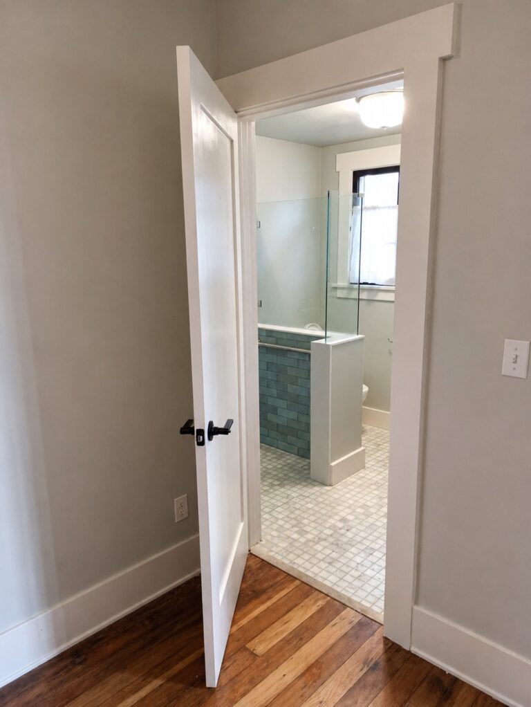 Shaker interior door from hallway into bathroom with craftsman header — Los Angeles