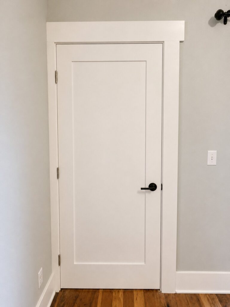 Shaker interior door with custom craftsman header molding — Los Angeles