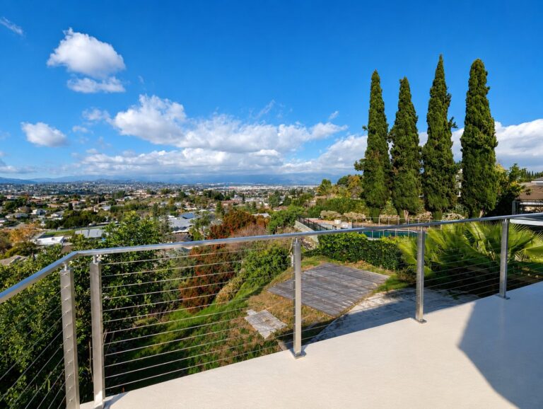 Stainless cable railing on hillside terrace with panoramic LA view by ProHands