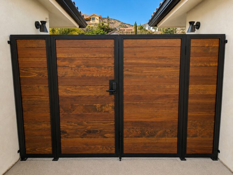 Main double gate with flanking panels, black steel + dark wood, LA hillside