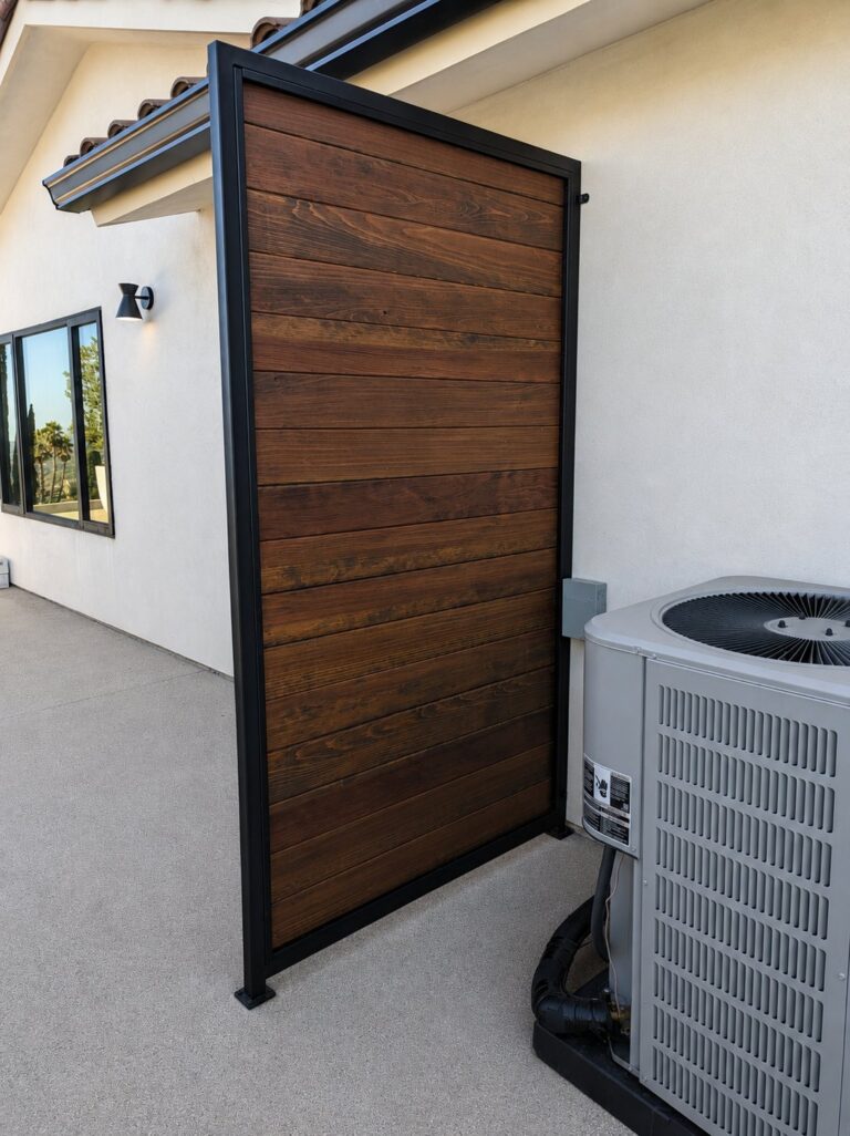 Steel-frame wood privacy panel hiding HVAC condenser, LA