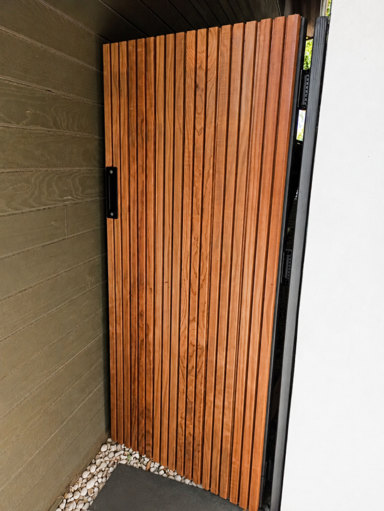 Interior view of custom redwood slat gate on welded steel frame with black hardware — Los Angeles ProHands