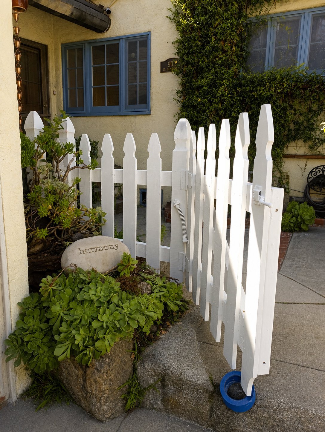 Close-up of French Gothic picket caps on white wood fence in LA
