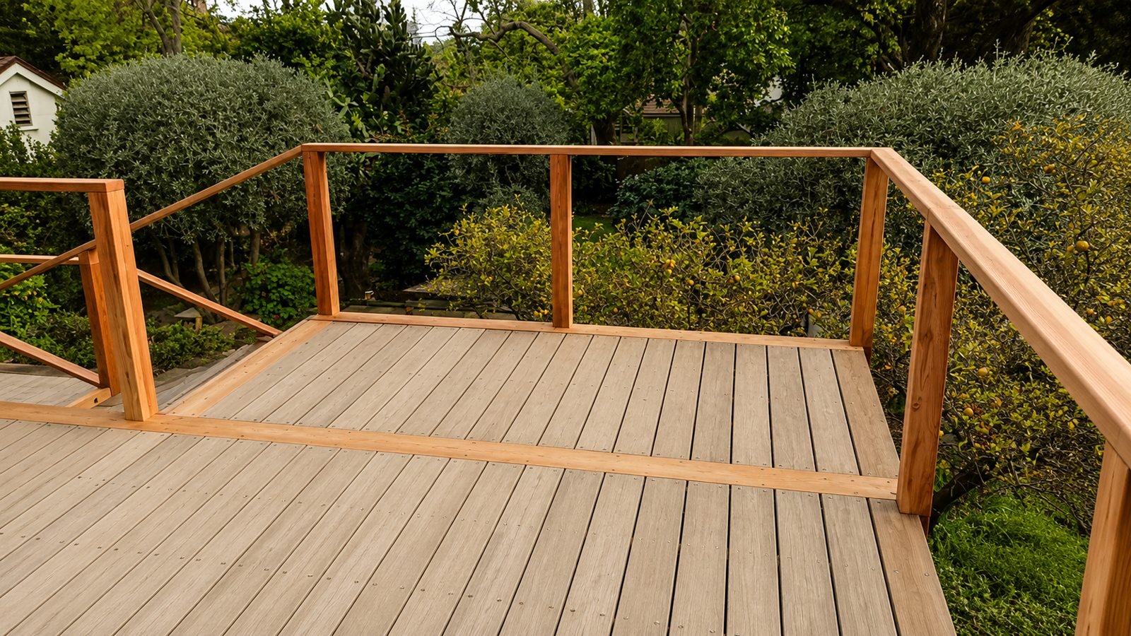 Wide view of rebuilt multi-level hardwood deck with wood-and-cable railing, Pasadena