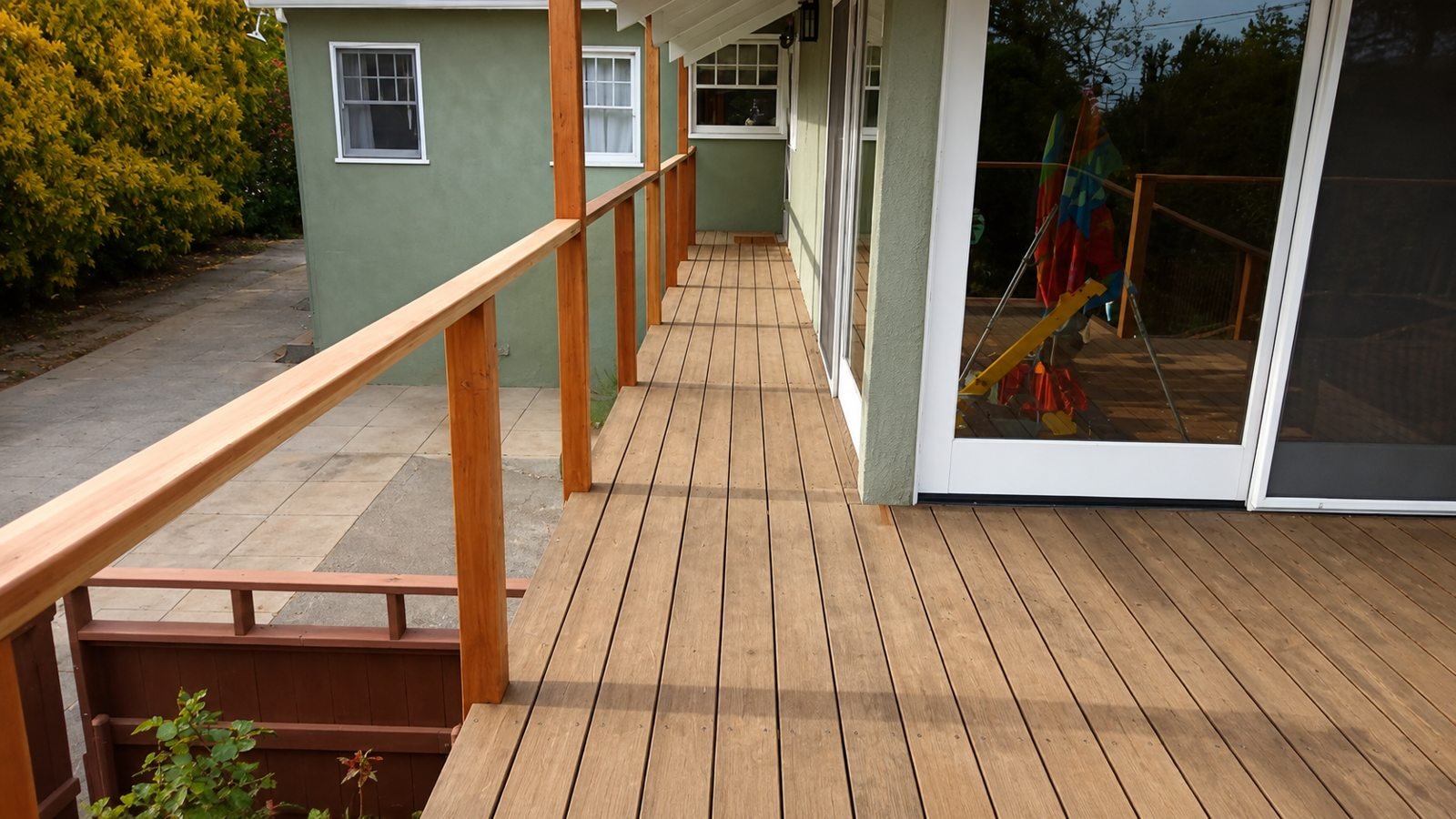 Long walkway deck along the house with new railing — Pasadena deck rebuild