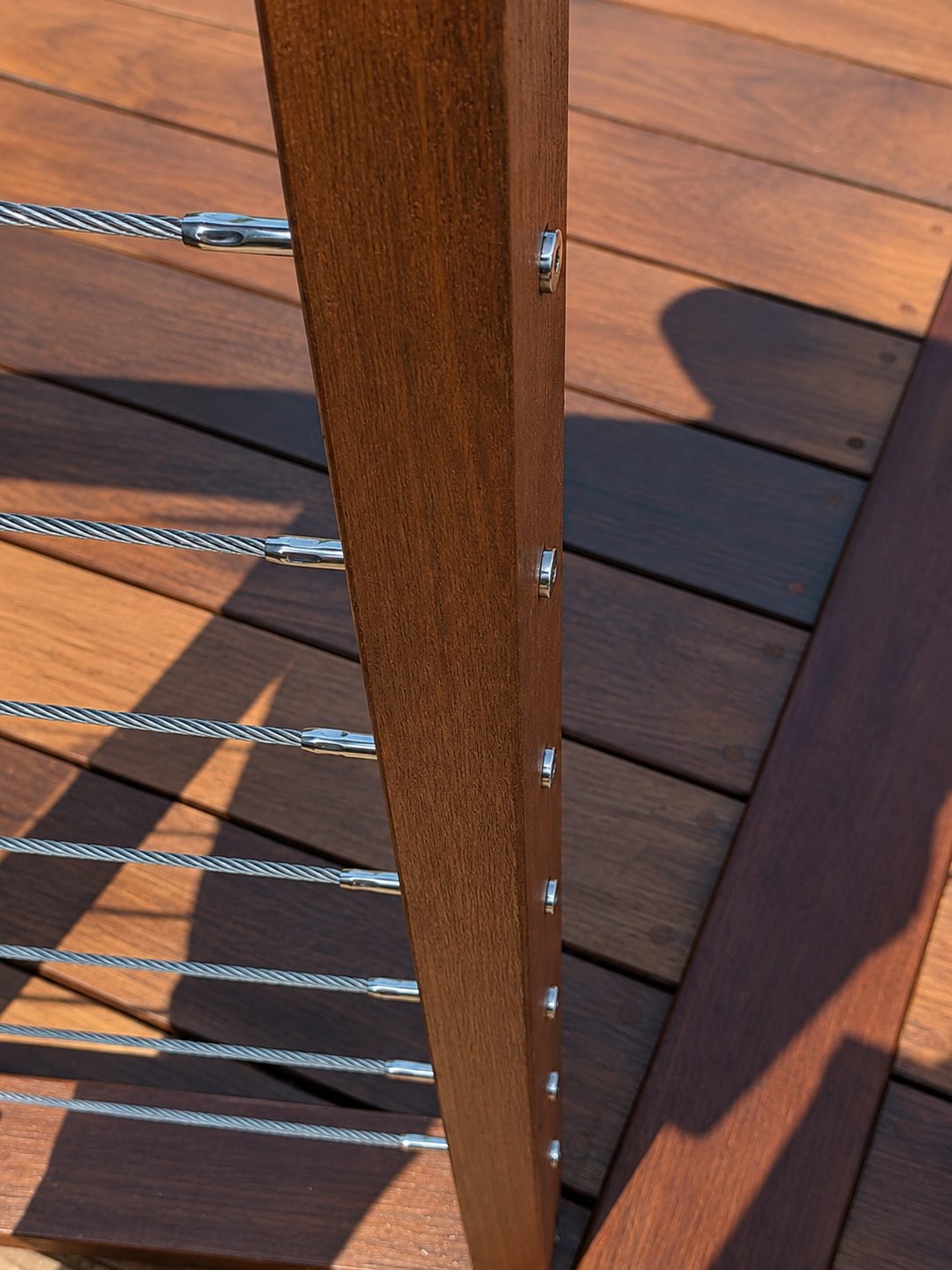 Stainless cable railing tensioner detail on ipe deck — Pasadena