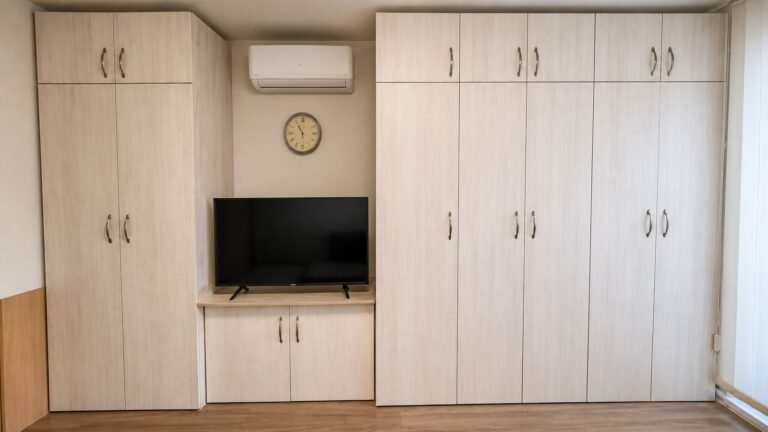 Custom-built apartment media wall cabinets with TV shelf, wardrobes and HVAC surround — Los Angeles ProHands
