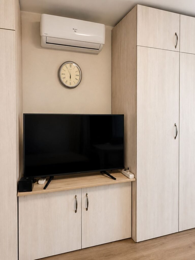 Custom apartment cabinets with TV corner and fitted wardrobe in light wood finish — ProHands Los Angeles