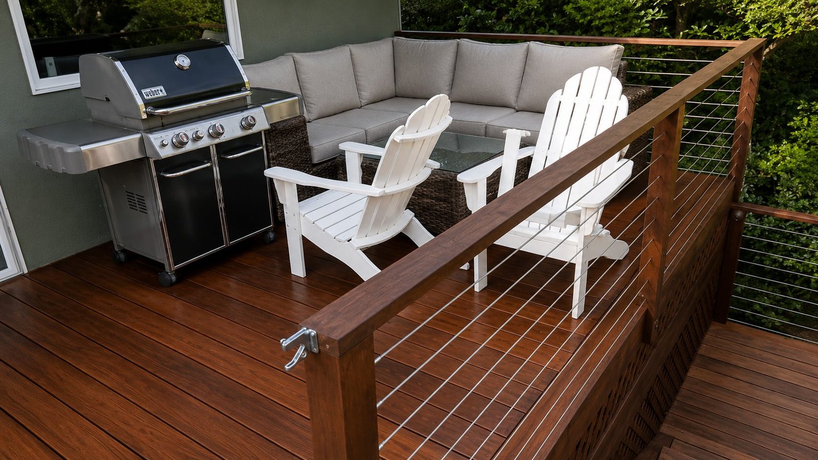 Reclaimed hardwood deck with stainless cable railing, outdoor lounge and grill by ProHands Pasadena