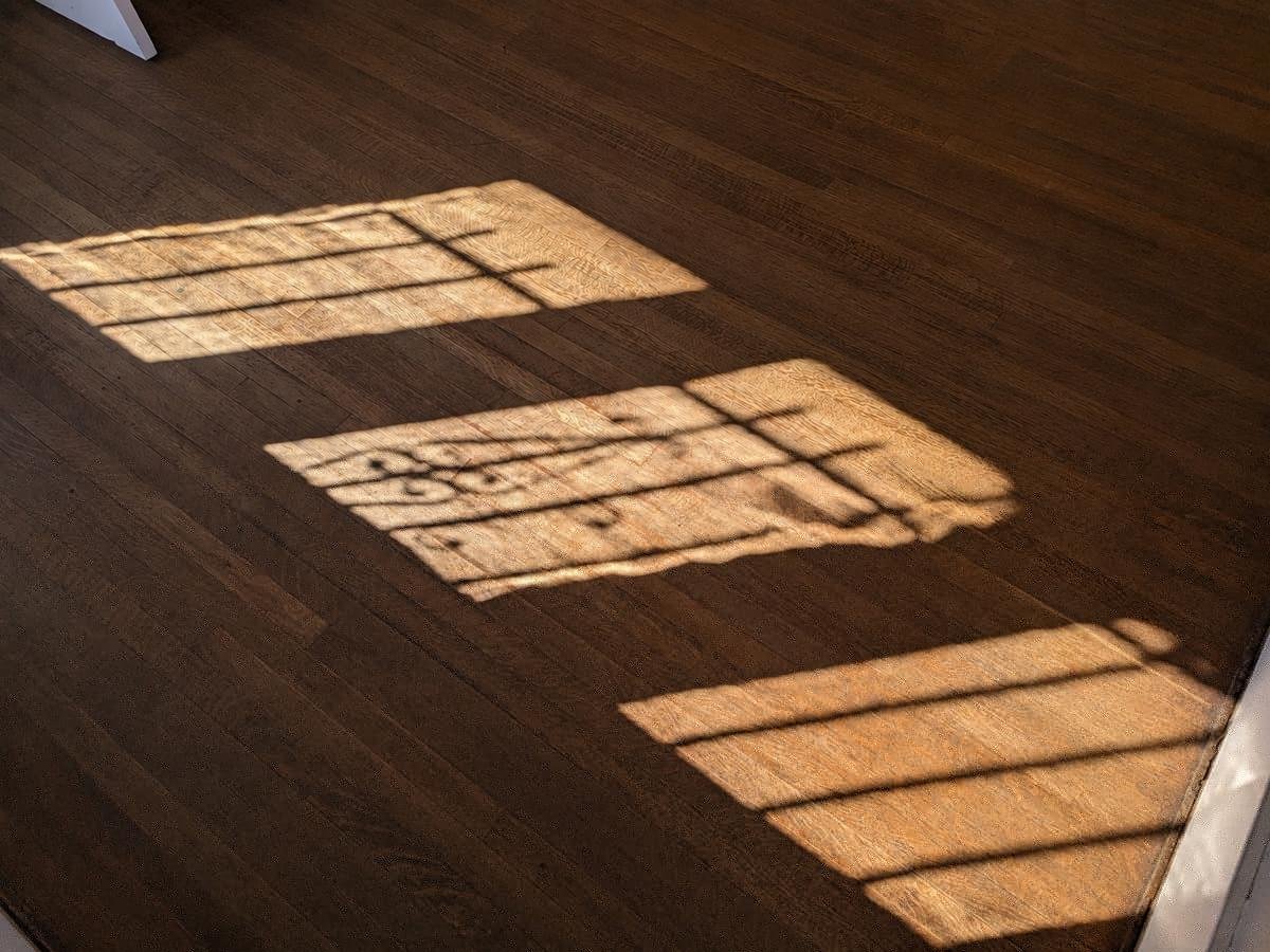 Close-up of restored dark-stained oak parquet grain in Los Angeles home — ProHands