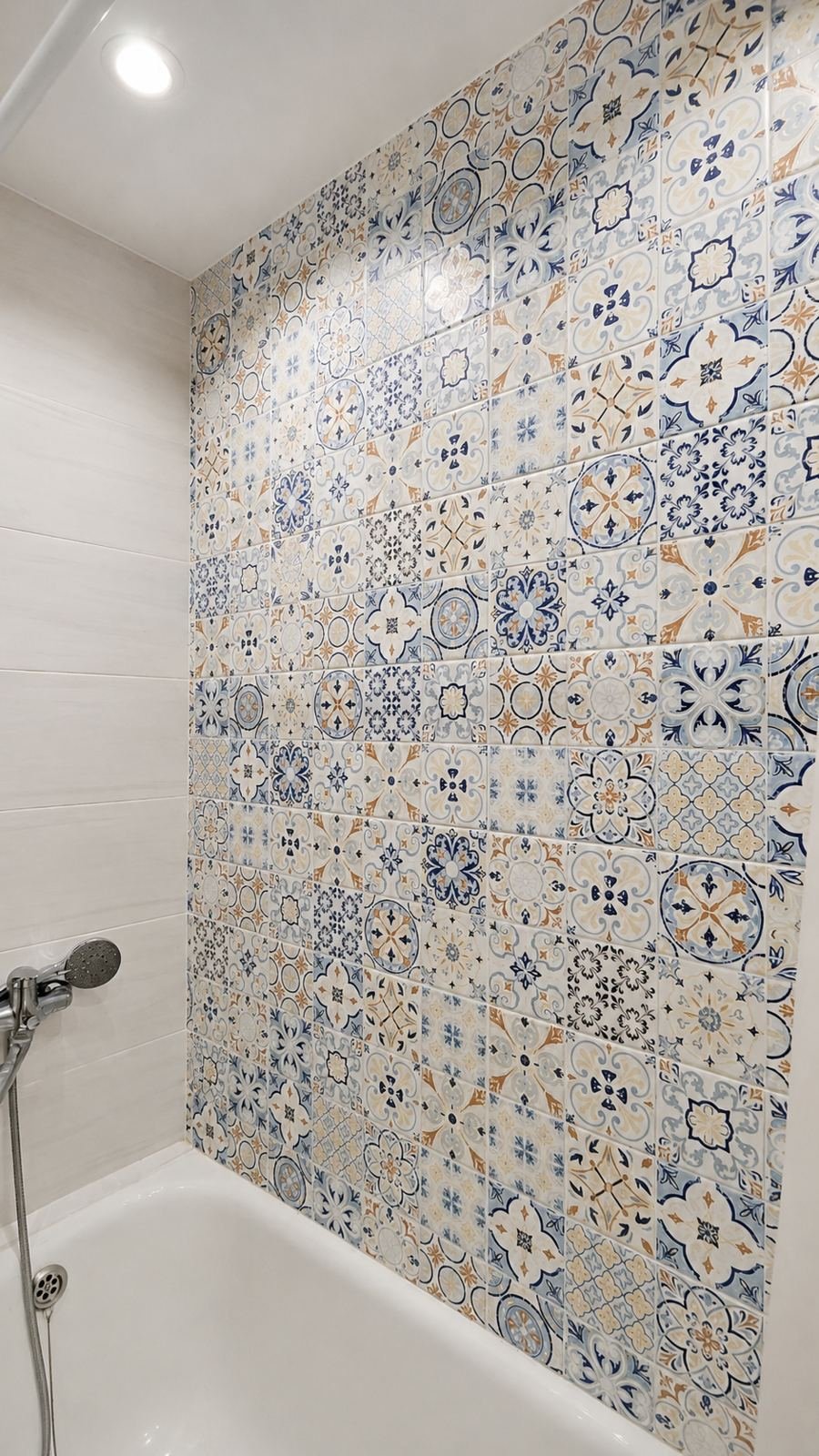 Patterned encaustic-look ceramic tile full-height feature wall on bathroom tub back wall — ProHands Los Angeles