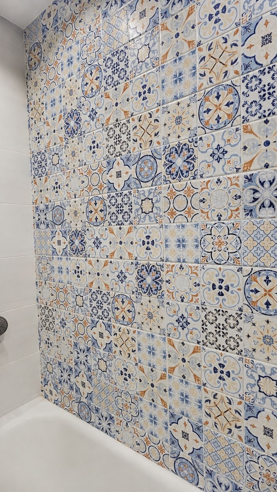 Close-up of patchwork Portuguese and Moroccan patterned ceramic tile — ProHands Los Angeles bathroom