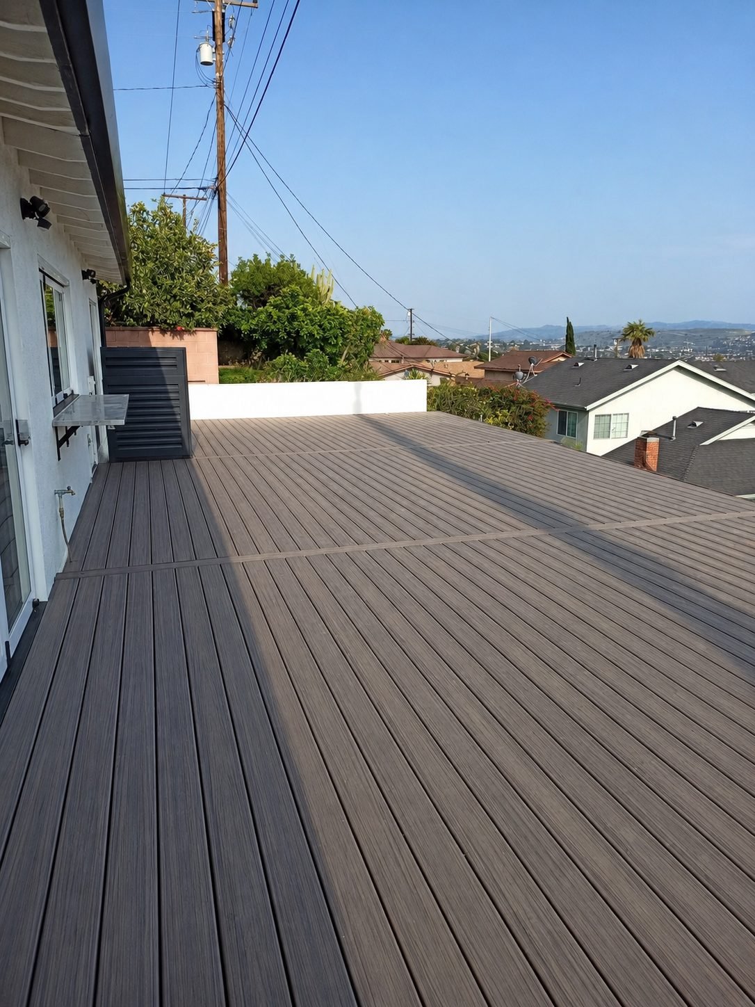 Composite deck boards close-up showing grain texture and hidden-fastener spacing — ProHands Los Angeles