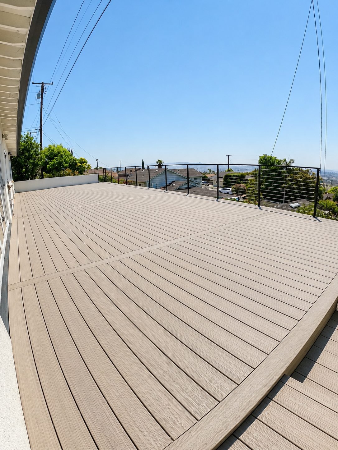 Composite deck corner detail with picture-frame border in grey composite — ProHands Los Angeles