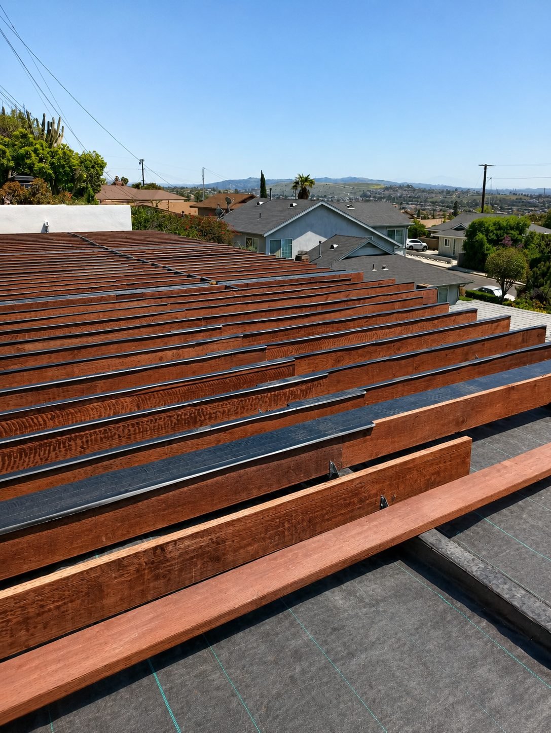 Full surface of new composite deck — modern grey boards on hillside home — ProHands Los Angeles