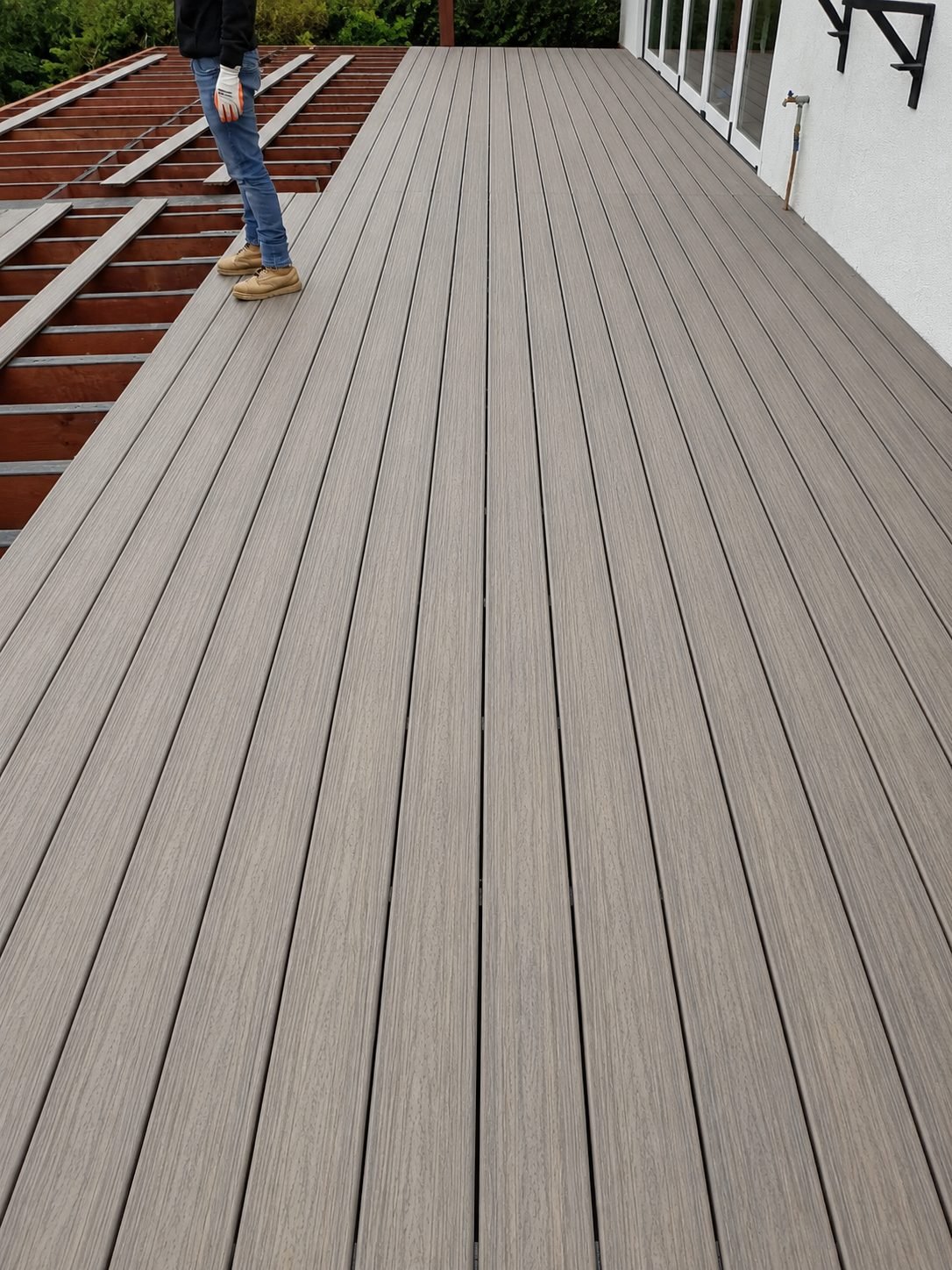 Composite deck installation in progress — new boards laid over freshly-built joist substructure — ProHands Los Angeles
