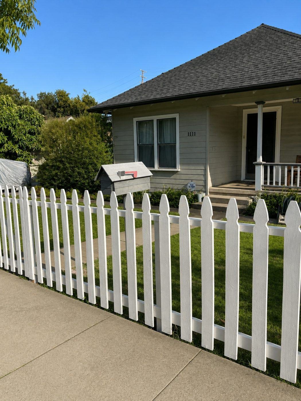 White picket fence in front of a Craftsman bungalow with mailbox and porch in San Marino, Los Angeles — ProHands