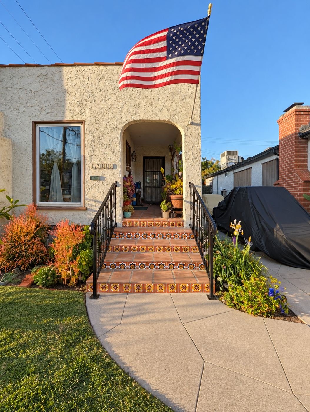 Spanish-style LA stucco home with new ProHands-fabricated custom wrought-iron handrails on both sides of the entry stairs — ProHands