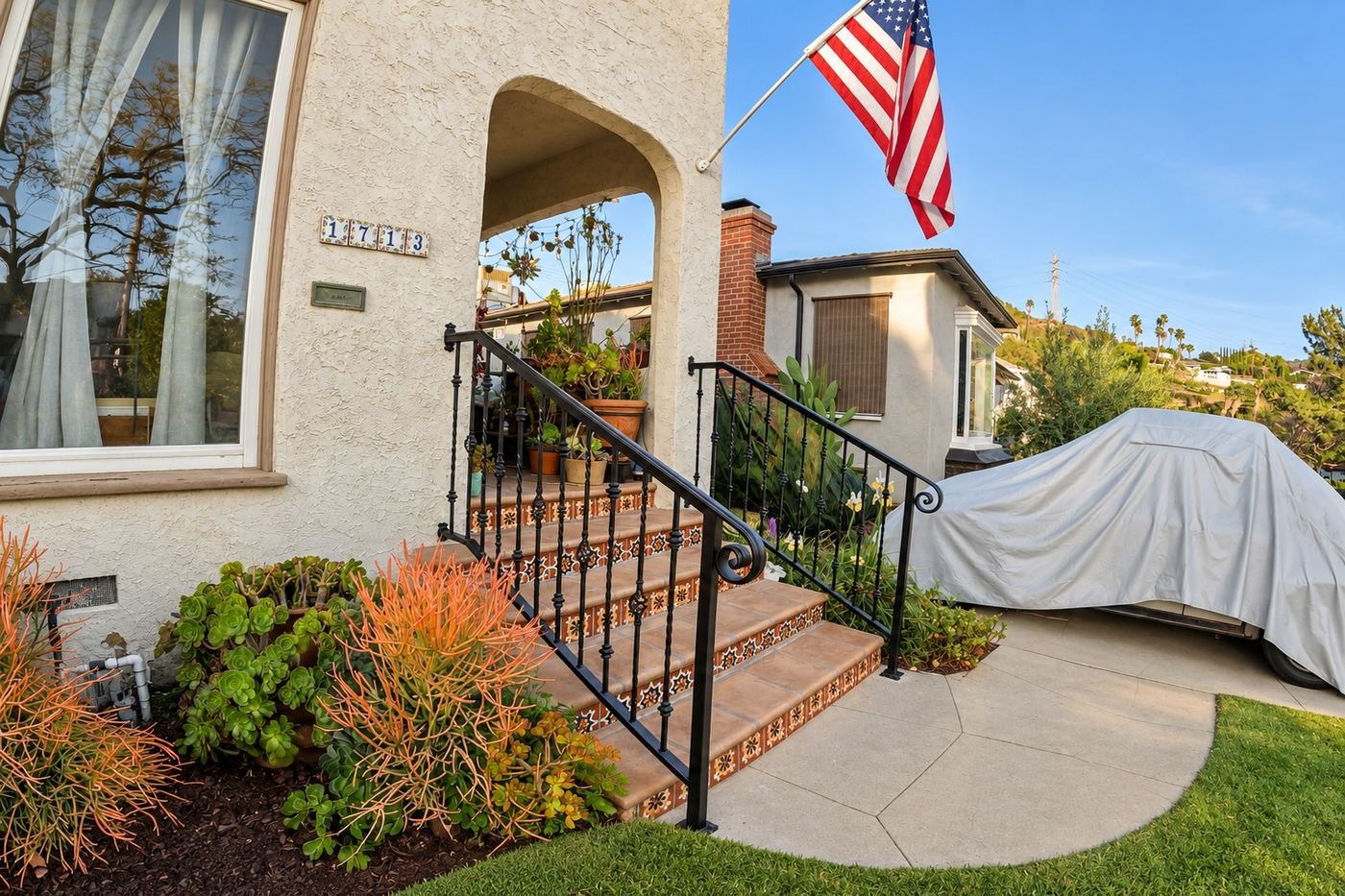 Wide side view of a Spanish-style LA home at golden hour with new custom wrought-iron handrails we built from scratch — ProHands