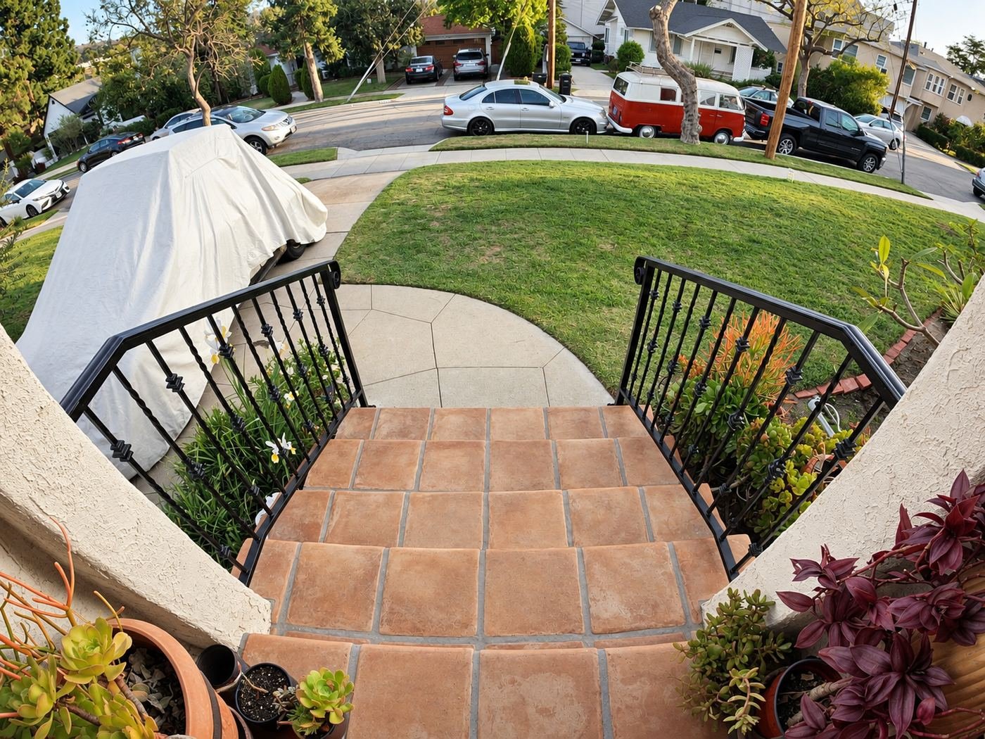 Looking down the new ProHands wrought-iron handrails from the top of the entry porch — classic red VW bus parked across the LA street