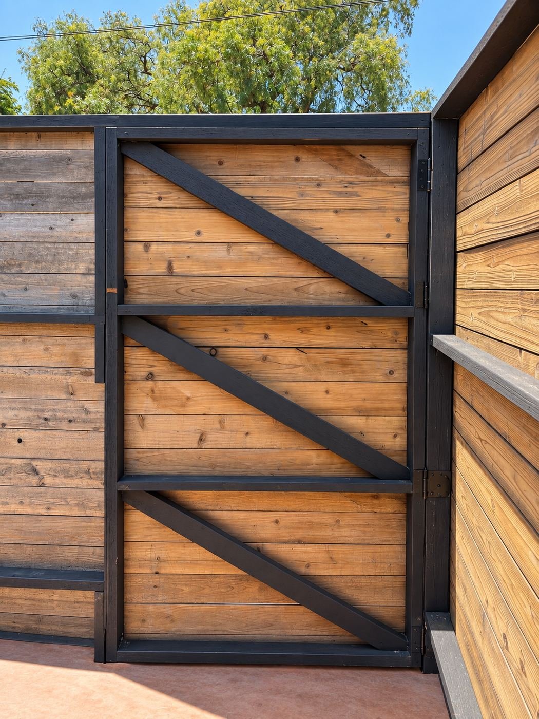 Repaired wood gate with new black Z-brace and transparent-stained boards — ProHands LA