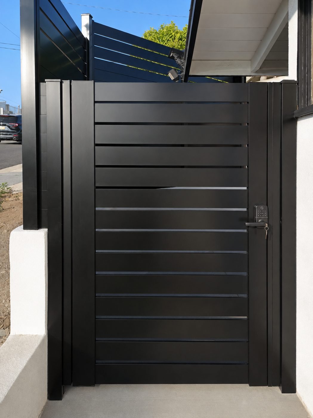 Modern horizontal aluminum slat pedestrian gate in matte black with keypad smart lock, 2-inch slats semi-privacy spacing, white stucco wall — ProHands Los Angeles