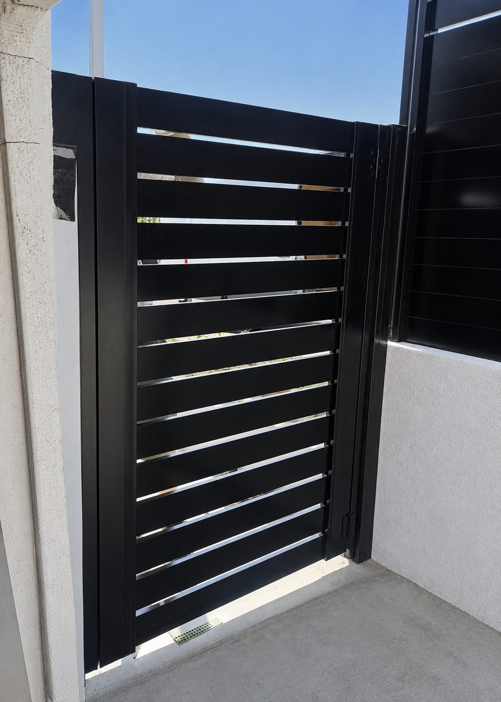 Open view through horizontal aluminum slat gate showing semi-privacy spacing — ProHands Los Angeles
